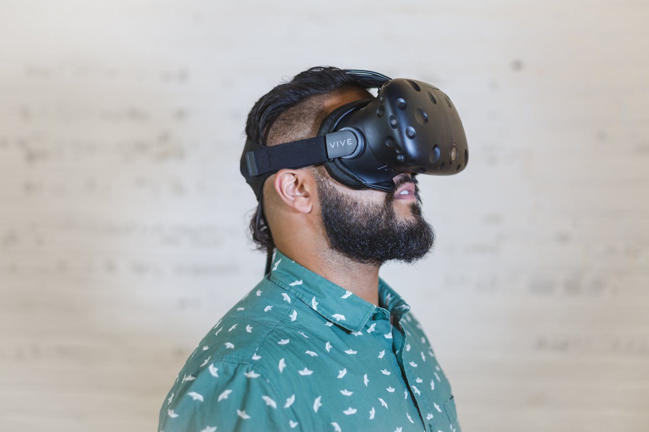 Adult male using a virtual reality headset for immersive experience indoors.
